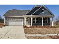 Charming single-story home featuring a stone facade, attached two-car garage and covered front entrance at 218 Miramar Dr, York, SC 29745