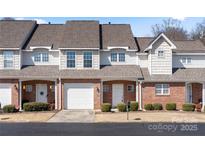 Charming townhome with brick facade, white accents, and well-maintained landscaping at 304 Valley Brook Se Ln, Concord, NC 28025