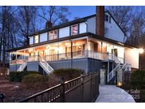 Stunning two-story home with a large, inviting porch and manicured landscaping, perfect for outdoor living at 368 Fairfield Ct, Mount Gilead, NC 27306