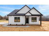 Charming single-Gathering home with a modern farmhouse design, black trim, and manicured lawn at 4055 Miller Rd, Salisbury, NC 28147