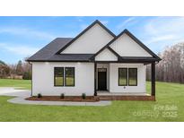 Charming new construction home featuring white siding, black trim, and a well-manicured lawn at 4055 Miller Rd, Salisbury, NC 28147