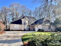 Charming single-Gathering home with a well-maintained lawn and a circular driveway at 420 Medearis Dr, Charlotte, NC 28211