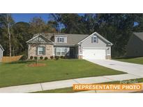 Charming two-story home with stone accents, a manicured lawn, and a two-car garage at 6347 Honor Ave, Midland, NC 28107