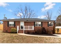 Charming brick home with a well-manicured lawn and inviting front porch, perfect for enjoying the outdoors at 703 E Mills Dr, Landis, NC 28088