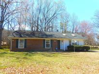 Charming single-story brick home with a well-maintained front yard and traditional architectural details at 8319 Golf Ridge Dr, Charlotte, NC 28277