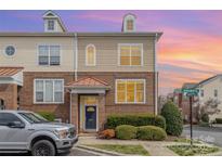 Charming two-story townhome with brick facade, well-maintained landscaping, and copper roof accents at 8410 Scotney Bluff Ave, Charlotte, NC 28273