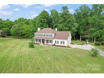 Stunning two-story home with a lush green lawn and mature trees at 1226 Flint Ct, Matthews, NC 28104