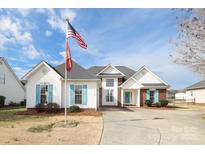 Charming two-story home with blue shutters, well-manicured landscaping, and an inviting entrance with American flag at 2003 Hemby Commons Pkwy, Indian Trail, NC 28079