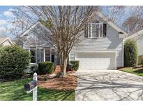 Charming home featuring a two-car garage, complemented by mature landscaping and a well-manicured front lawn at 2320 Christensens Ct, Charlotte, NC 28270