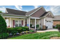 Charming single-story home with a cozy front porch and well-manicured landscaping at 313 Garner Dr, Salisbury, NC 28146