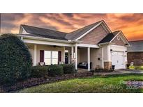 Charming single-story home with a welcoming front porch and well-maintained landscaping at 313 Garner Dr, Salisbury, NC 28146