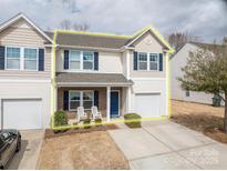 Charming two-story home featuring a cozy front porch, a well-maintained lawn, and an attached single-car garage at 4075 Creekstone Trce, Gastonia, NC 28056