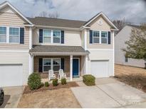 Charming two-story home featuring a cozy front porch, a well-maintained lawn, and an attached single-car garage at 4075 Creekstone Trce, Gastonia, NC 28056