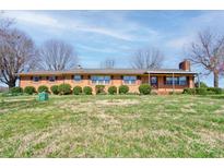 Charming brick ranch home featuring manicured landscaping and a well-maintained lawn at 5830 W Nc 10 Hwy, Hickory, NC 28602