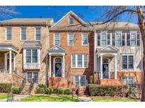 Charming brick townhomes with well-maintained landscaping and inviting front entrances on a sunny day at 663 Sixth Baxter Xing, Fort Mill, SC 29708