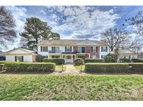 Charming two-story townhome with lush landscaping and classic architectural details at 7101 Quail Meadow Ln, Charlotte, NC 28210