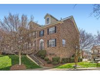 Brick townhome featuring manicured lawn, trimmed shrubs, and stairs leading to the entrance at 8436 Summerford Dr, Charlotte, NC 28269