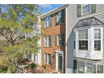 Charming two-story townhome with brick facade, neutral siding, and professionally landscaped front yard at 12727 Bullock Greenway Blvd, Charlotte, NC 28277