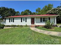 Charming one-story home features a red roof, light siding, and a well-manicured lawn at 2027 Downey St, Rock Hill, SC 29732