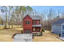 Charming two-story home with a well-manicured front yard and a one-car garage at 607 W Stanly St, Stanfield, NC 28163