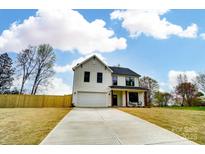 Charming new construction home with a two-car garage and a large driveway and a beautiful cloudscape at 9615 Riviera Dr, Sherrills Ford, NC 28673