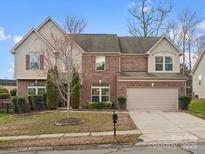 Charming two-story brick home with well-maintained landscaping and attached two-car garage at 9823 Shearwater Nw Ave, Concord, NC 28027