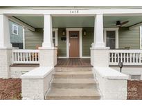 Inviting front porch with classic columns and a charming entrance to the home at 1418 Seigle Ave, Charlotte, NC 28205