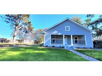 Charming single-story home featuring a covered front porch, fresh lawn, and inviting curb appeal at 155 31St Sw St, Hickory, NC 28602