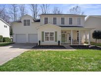 Charming two-story home with a well-manicured lawn, attached two car garage and inviting front porch at 18948 Kanawha Dr, Cornelius, NC 28031