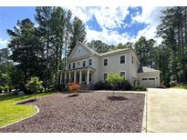 Charming two-story home with a covered front porch and a well-manicured lawn at 220 Kenway Loop, Mooresville, NC 28117