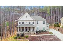 Charming two-story home with a welcoming front porch and beautifully landscaped yard at 220 Kenway Loop, Mooresville, NC 28117