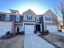 Charming townhome with a one car garage, driveway, and manicured lawn at 2623 Aubrey St, Monroe, NC 28110