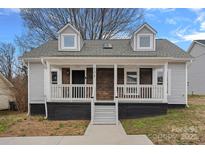 Charming home with a covered front porch and two dormer windows, offering a welcoming curb appeal at 504 Leland St, Charlotte, NC 28214