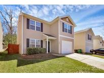 Charming two-story home featuring neutral siding, black shutters, well-manicured lawn, and an attached one-car garage at 5830 Kelden Walker Ln, Charlotte, NC 28269