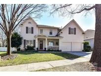 Charming two-story home featuring a covered front porch and a two-car garage at 8412 Westmoreland Lake Dr, Cornelius, NC 28031