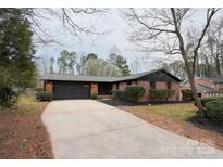 Charming brick home with a spacious driveway and well-maintained landscaping at 908 Coventry Rd, Kannapolis, NC 28081