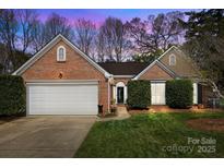 Charming brick home with manicured lawn, two-car garage, and inviting entryway at 11542 Laurel View Dr, Charlotte, NC 28273