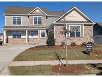 New construction home with stone and siding exterior, professionally landscaped front yard, and a for sale sign at 1921 Hendricks St, Rock Hill, SC 29732