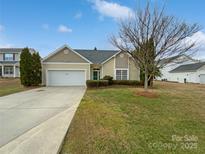 Charming single-story home featuring a manicured lawn, attached garage, and inviting curb appeal at 2802 Eagle View Ln, Monroe, NC 28110