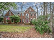 Charming two-story brick home featuring a well-manicured lawn and a welcoming front entrance at 3400 Thistle Bloom Ct, Charlotte, NC 28269