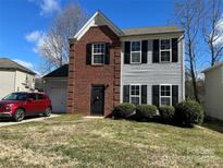 Two-story home featuring a combination brick and siding facade, complemented by black shutters at 3813 Brookchase Ln, Charlotte, NC 28205