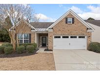 Charming brick home featuring a two-car garage and well-maintained landscaping at 4001 Perth Rd, Fort Mill, SC 29707