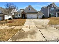 Charming single-Gathering home showcasing a three car garage and well-manicured lawn at 6132 Russo Ct # 124, Lancaster, SC 29720