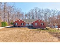Charming, one-story brick home with a well-maintained lawn and mature trees at 11 Heritage Ln, Shelby, NC 28150