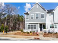 Charming two-story townhome with gray siding, white trim, and a well-maintained front yard at 118 Isleworth Ave, Mooresville, NC 28117