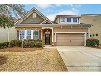 Charming home featuring a stone facade, two-car garage, and well-maintained landscaping at 120 Sycamore Dr, Lancaster, SC 29720