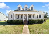 Charming two-story home featuring a large front porch, dormer windows, and a well-manicured lawn at 1249 Maddy Ln, Rock Hill, SC 29732