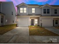 Charming townhome with a one car garage, well maintained lawn, and attractive front door at 142 S Bell Ave, Albemarle, NC 28001
