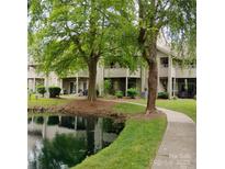 Charming exterior view featuring a pond and well-maintained landscaping at 2545 Stockbridge Dr, Charlotte, NC 28210