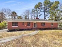 Charming red brick home with a well-maintained lawn and inviting walkway to the front entrance at 414 N Wylie St, Lancaster, SC 29720